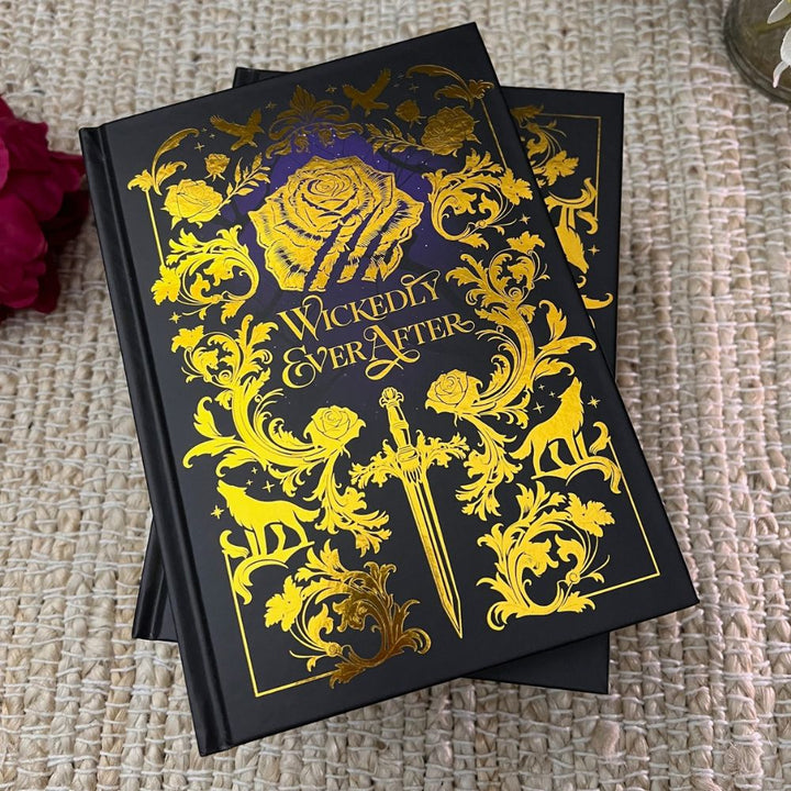 Gold foiled blank notebook with 'Wickedly Ever After' design on cover