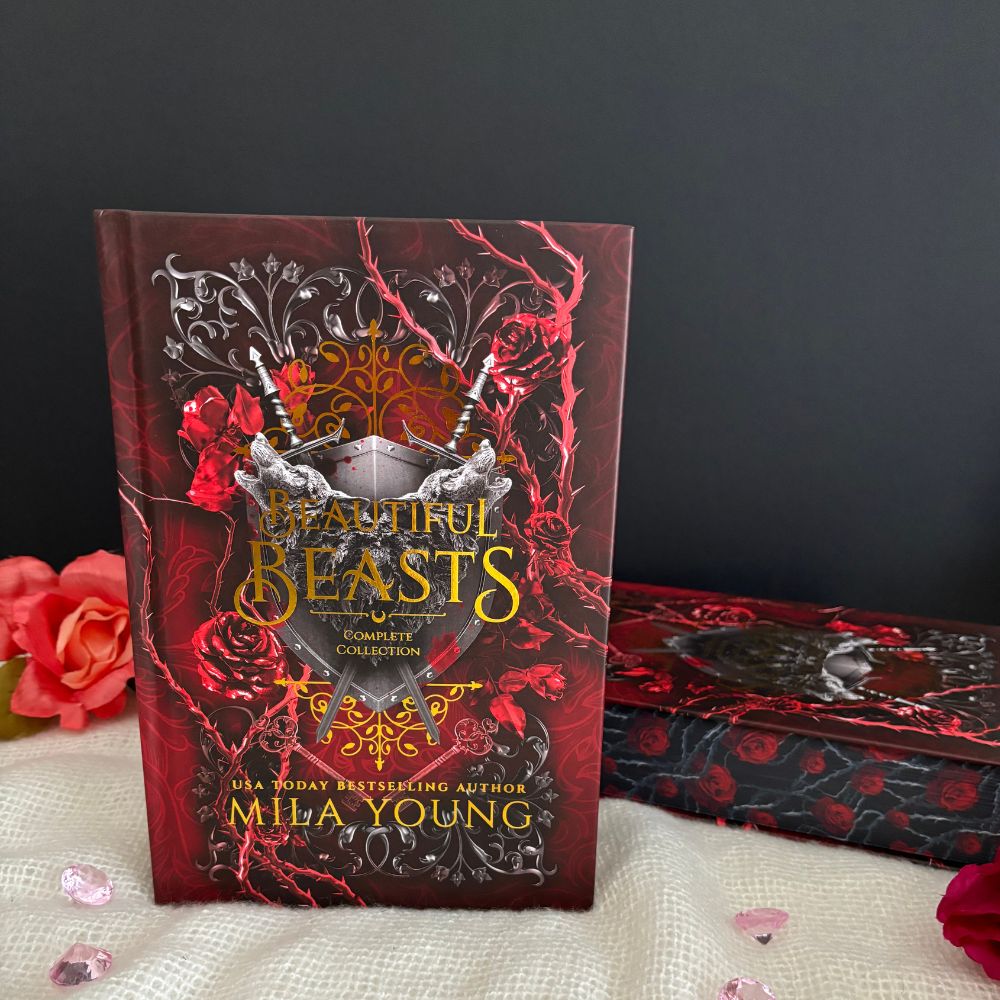 A damaged hardcover copy of Beautiful Beasts Special Edition Foil Hardback featuring a gold foil cover, colourful interior artwork, rose-designed luxe edging, and artistic chapter designs, showcasing its paranormal romance themes with a supernatural academy setting, wolves, vampires, and romantic intrigue