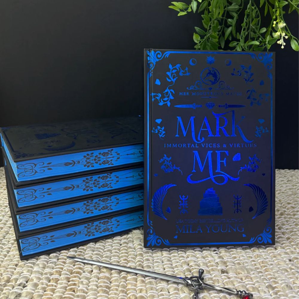 A heavily discounted damaged hardback edition of Mark Me Discreet: Special Edition Foil featuring a distressed cover with visible wear and tear, indicative of minor damage, showcasing a fantasy romance novel with dark themes, strong heroine, and mysterious monsters, shipped from the United States