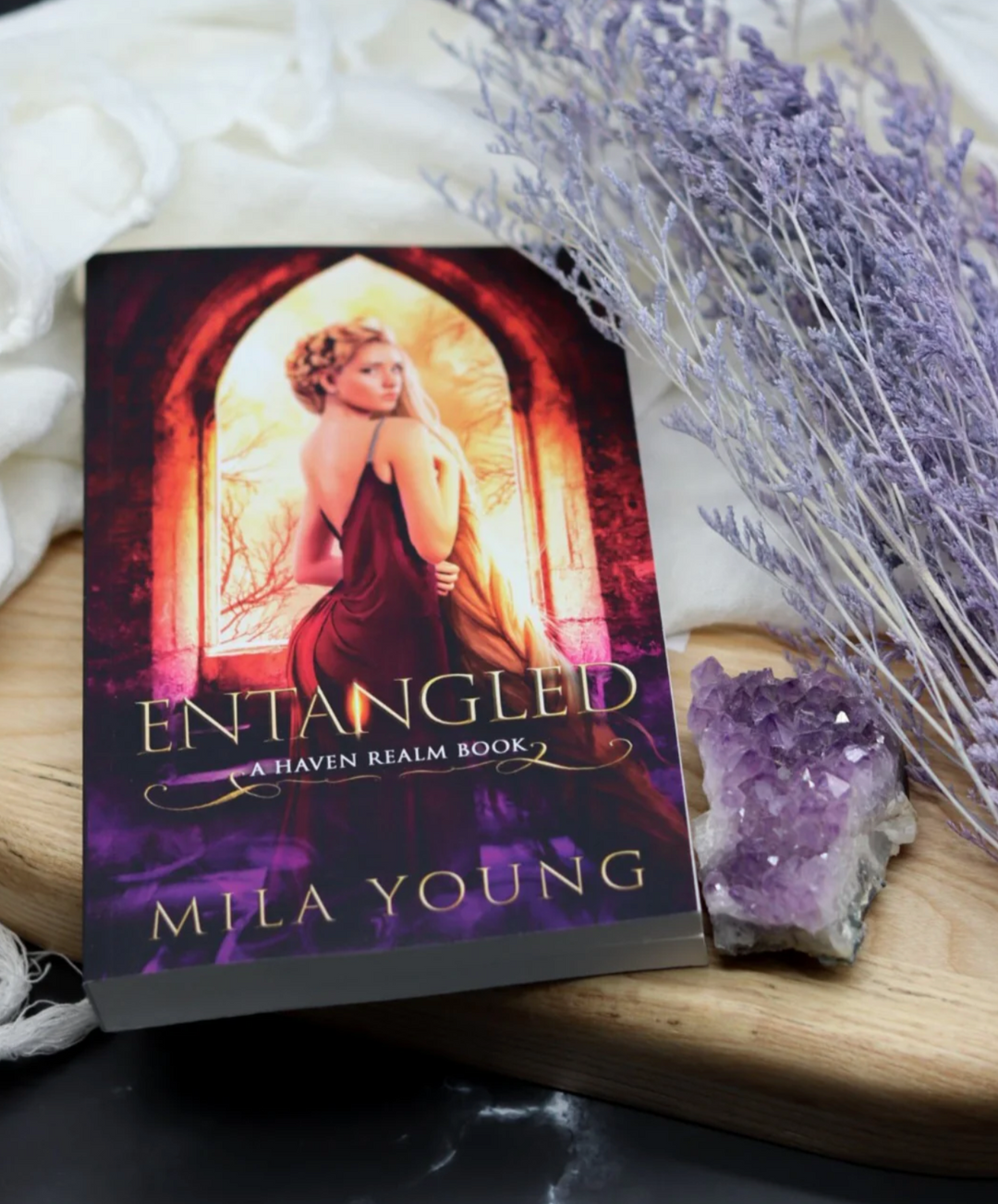 Heavily discounted damaged paperback edition of Entangled by DAMAGED BOOK (AUS), featuring a colourful cover illustrating a magical tower, fierce shifters, and a young girl with long hair, with minor visible wear and tear
