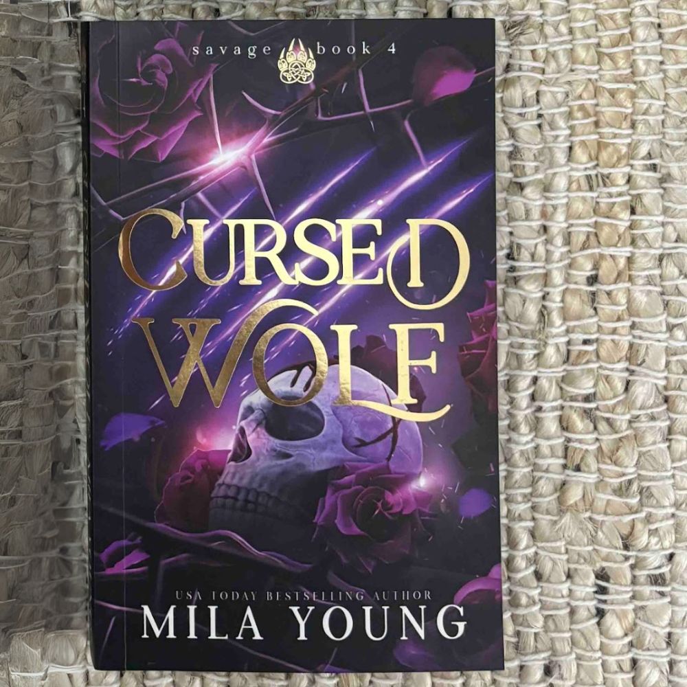 A heavily discounted damaged paperback copy of Cursed Wolf from the Savage Sector series, featuring wolf shifters, a passionate romance, and intense action, shipped from the United States